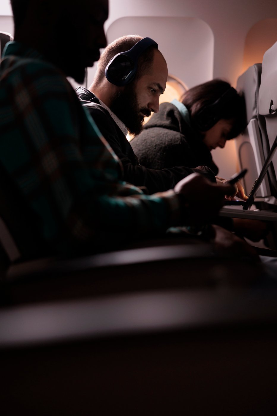 Passengers on a long-haul flight at sunset