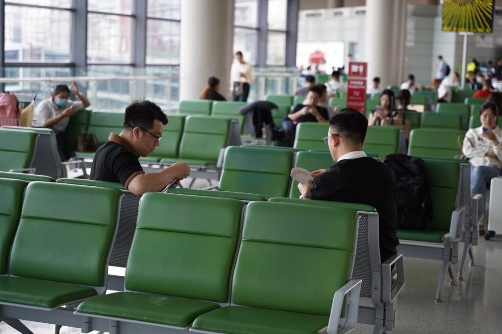 Travellers waiting in an airport terminal