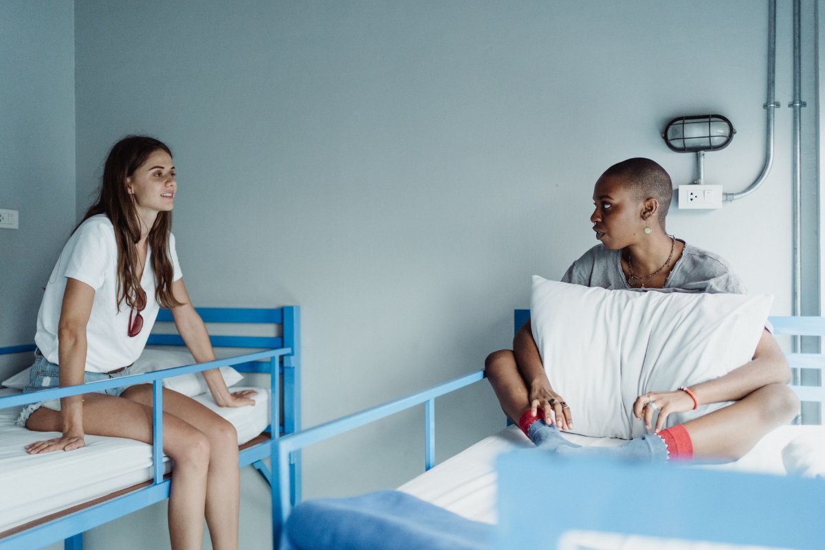 Travellers talking in a hostel common room