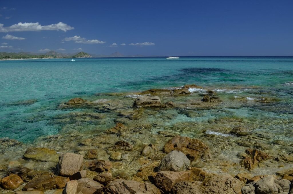 The turquoise water and rocky shore of the Sardinian coast