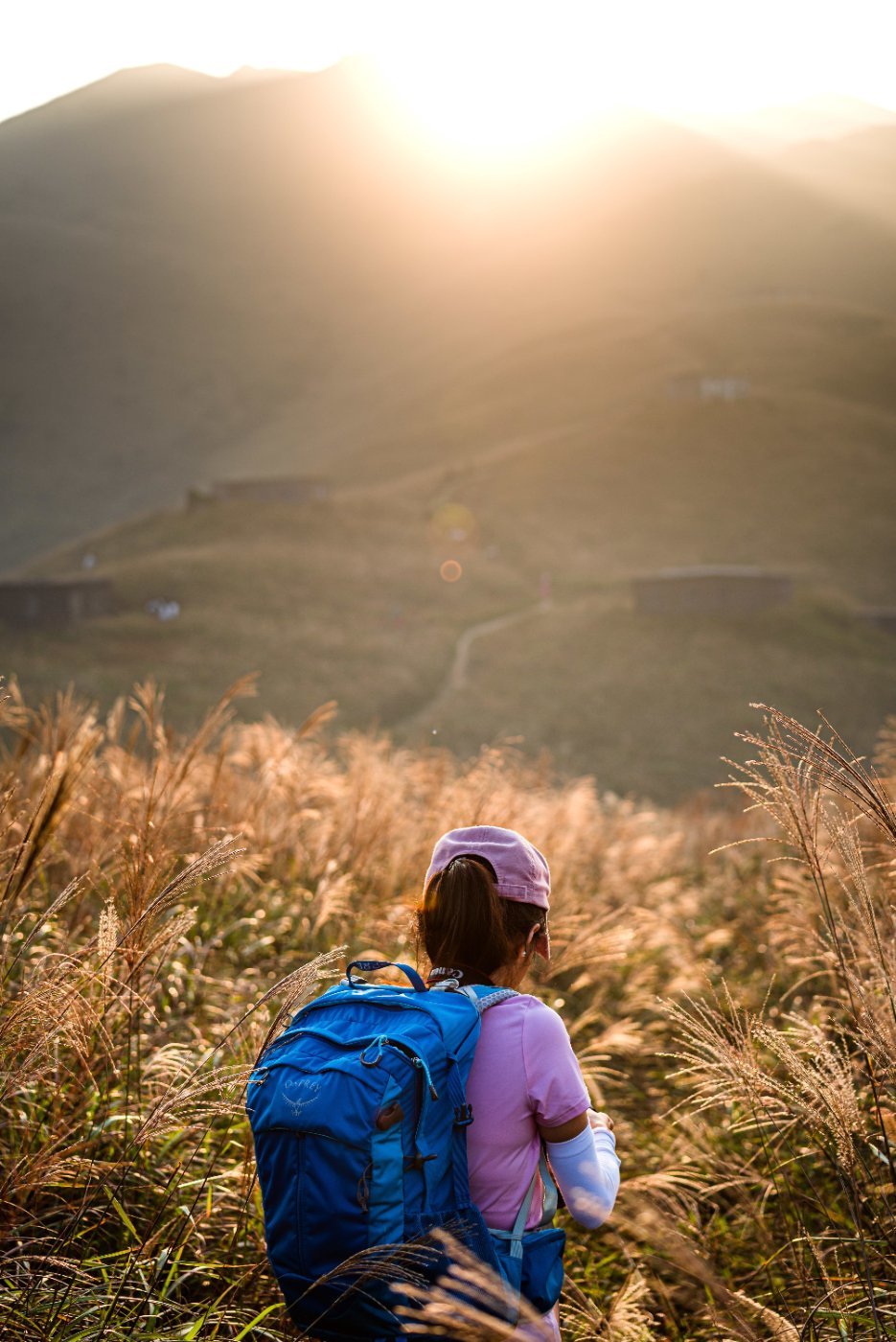 A solo hiker with a full pack at sunset