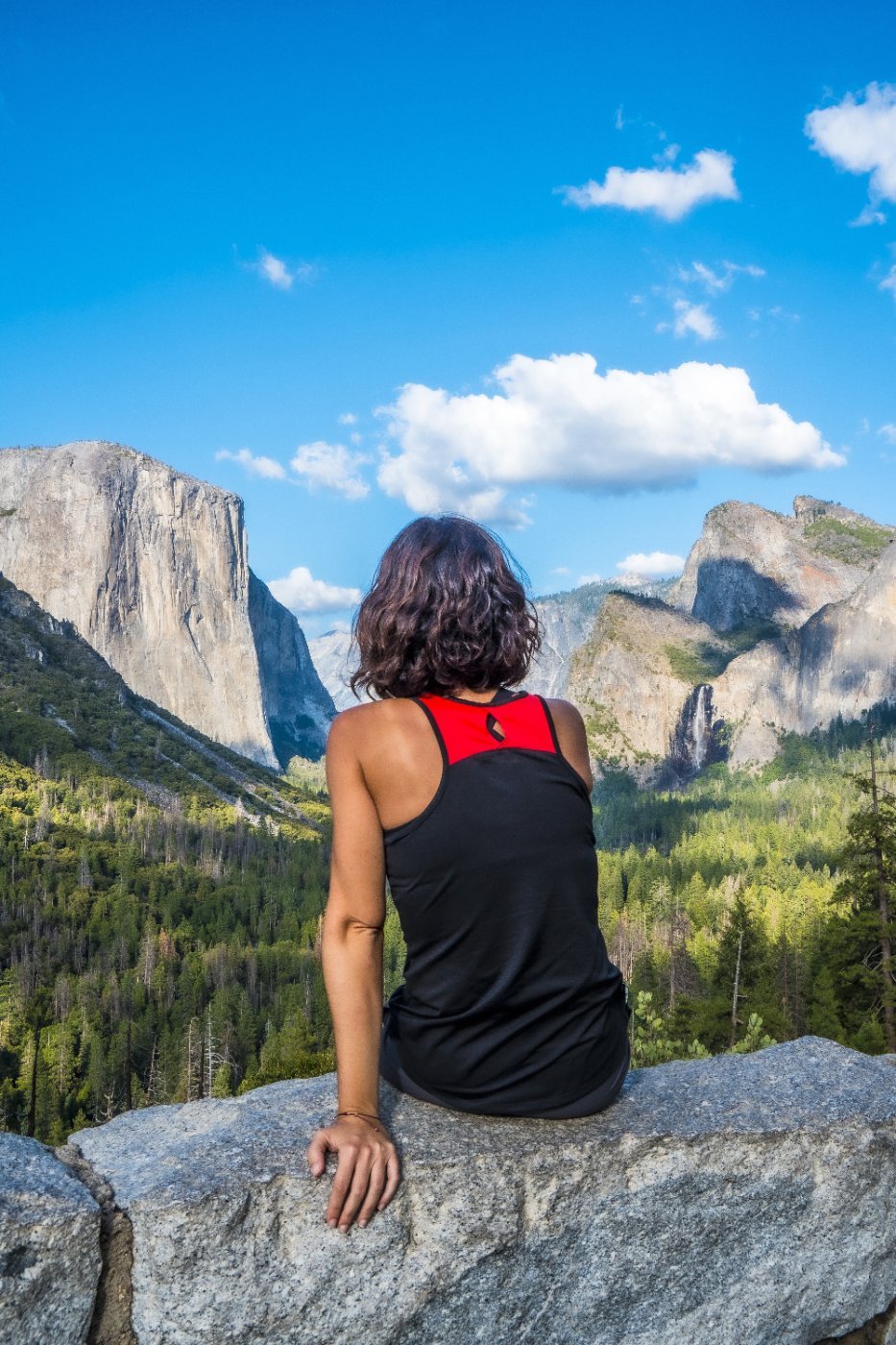 A solo traveller sitting above the valley in Yosemite National Park