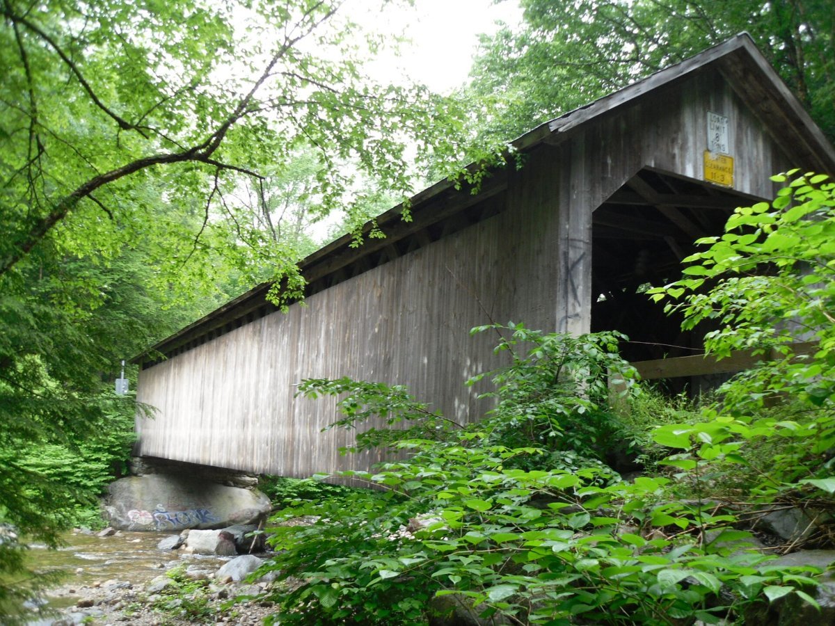 A wooden covered bridge in the Vermont hills