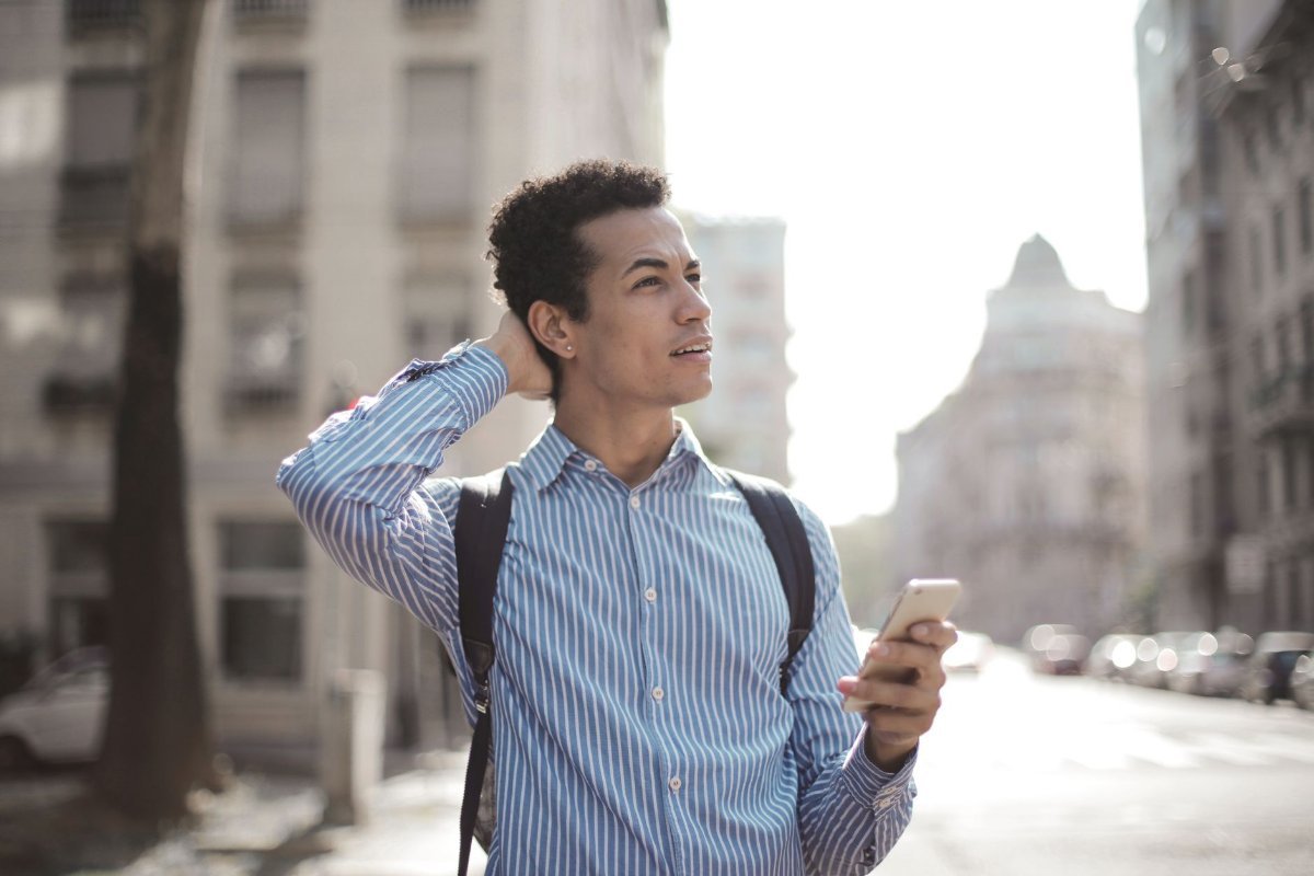 A traveller checking a phone on an unfamiliar street