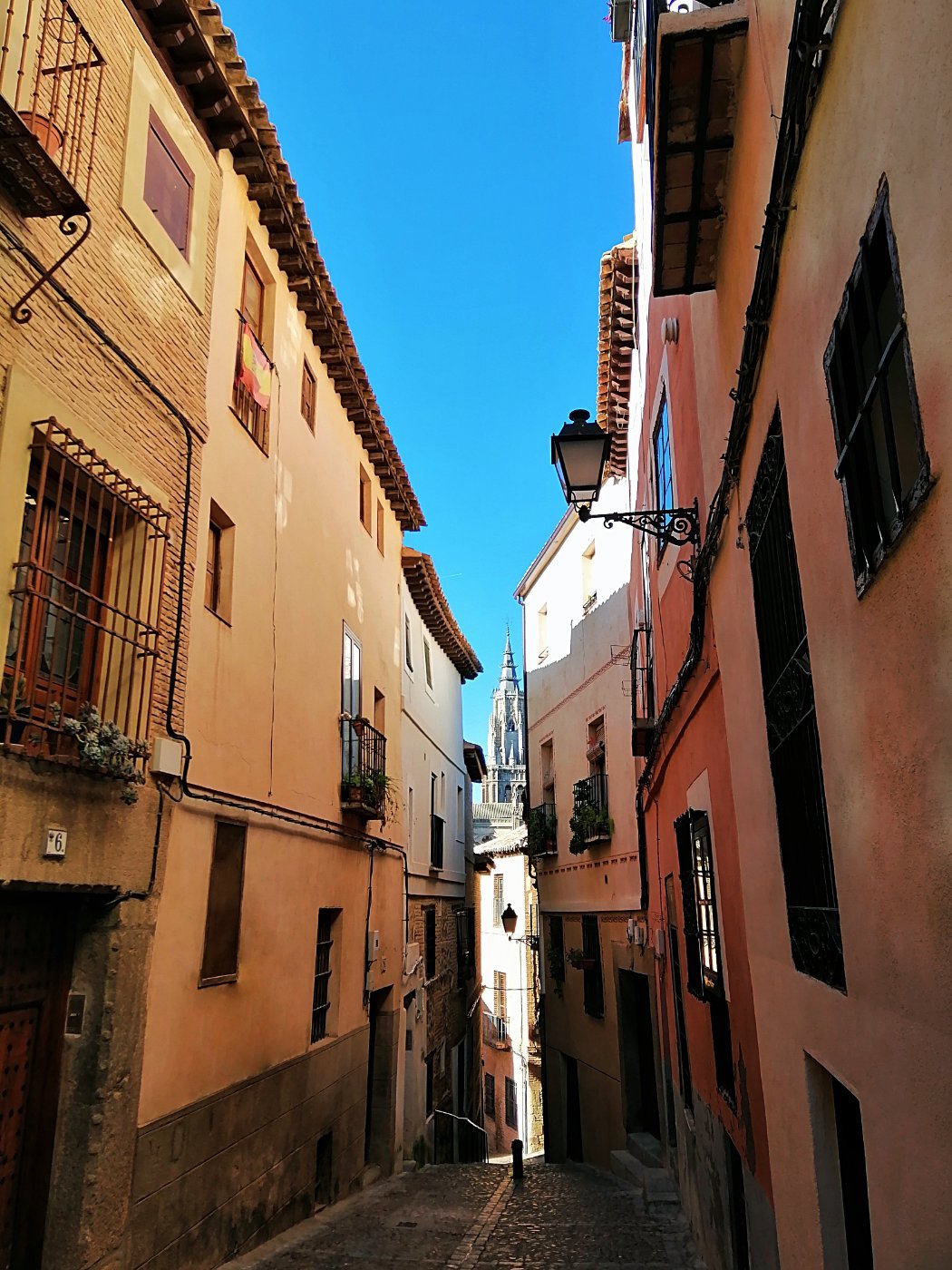 A narrow street with colourful buildings in Toledo, Spain