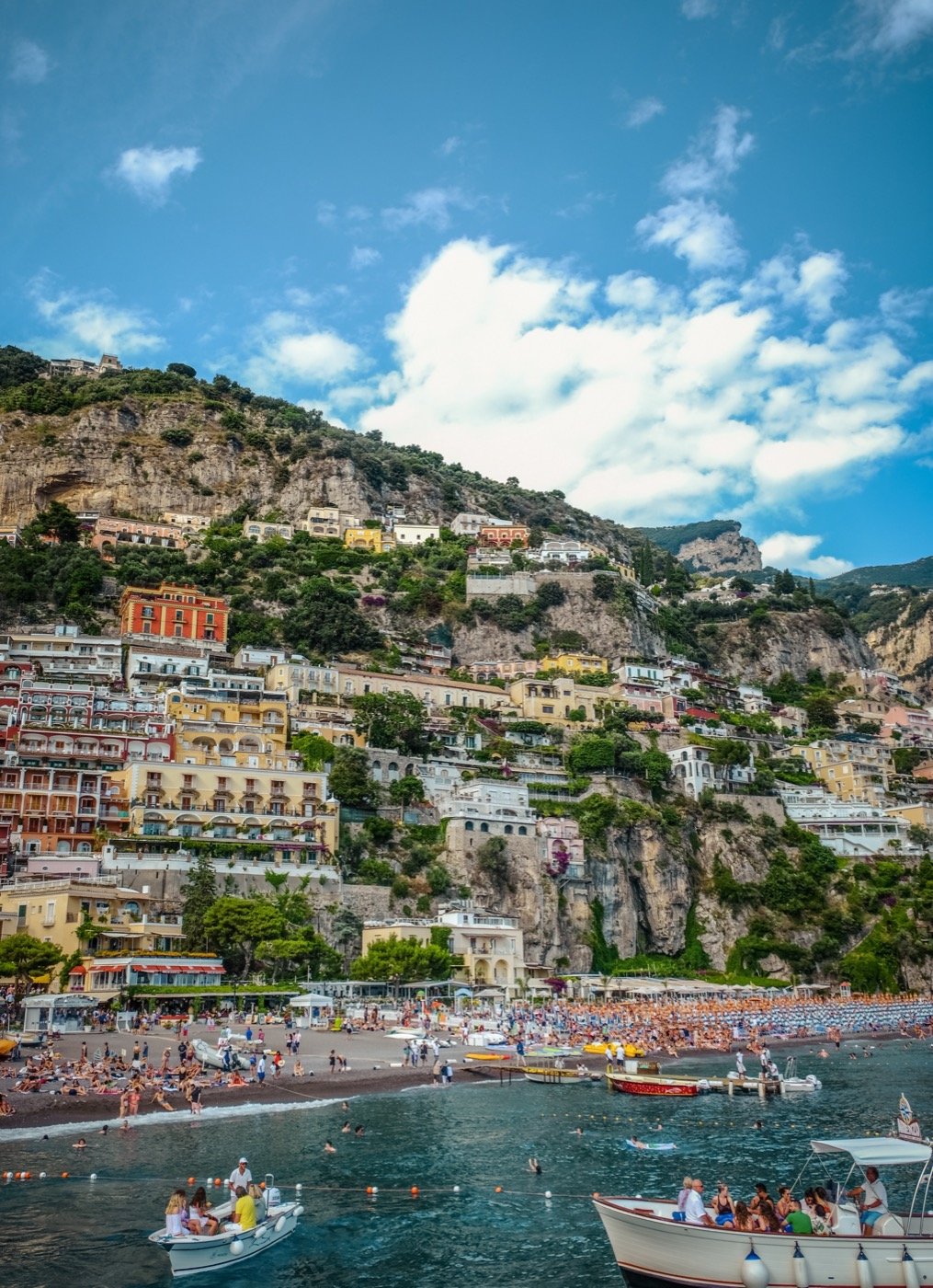 Colourful buildings stacked above the beach in Positano