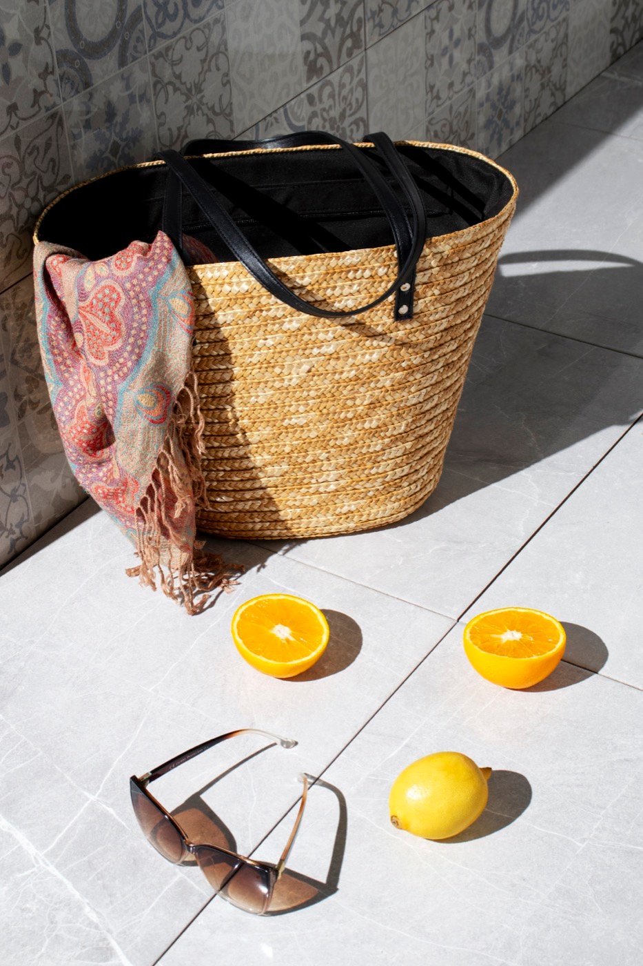 A woven tote bag packed for a day by the sea