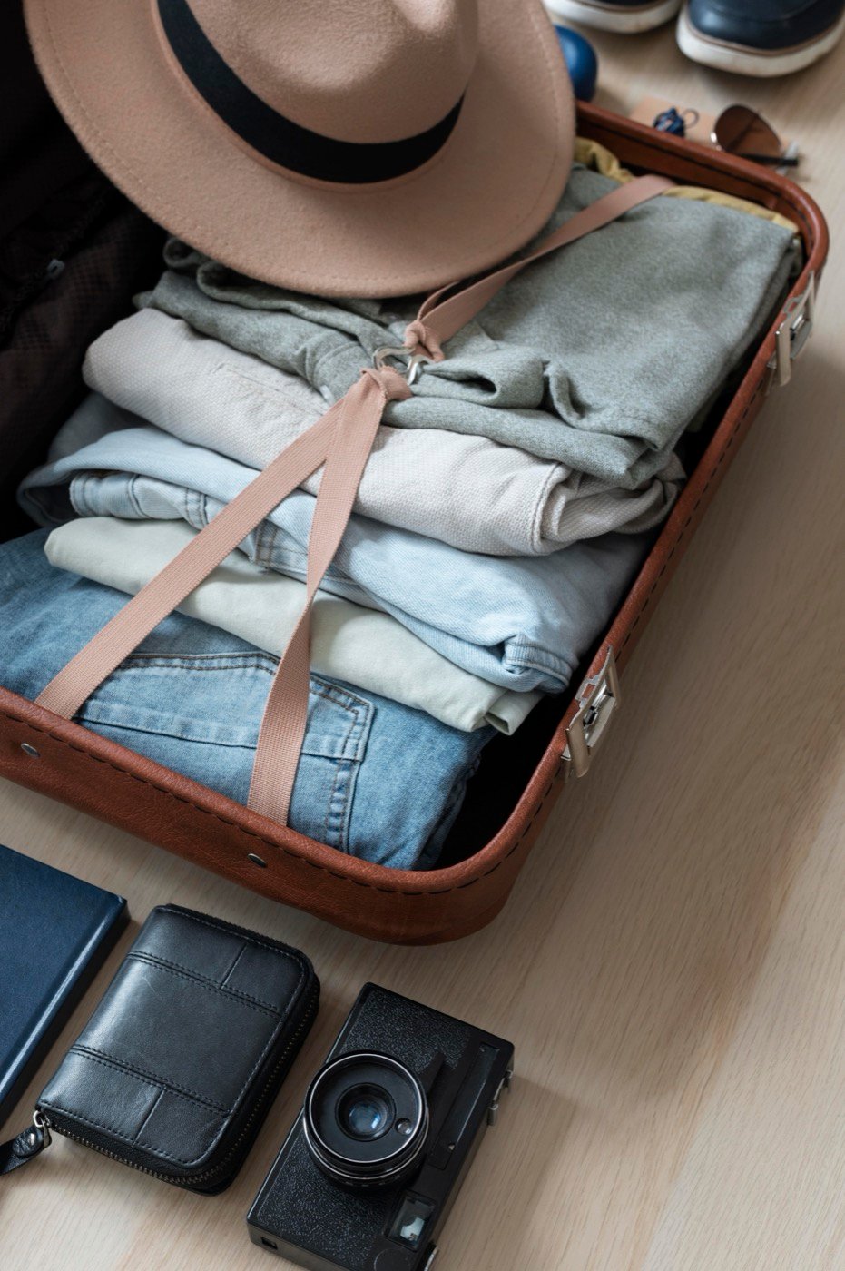 Clothes and accessories arranged neatly in an open suitcase