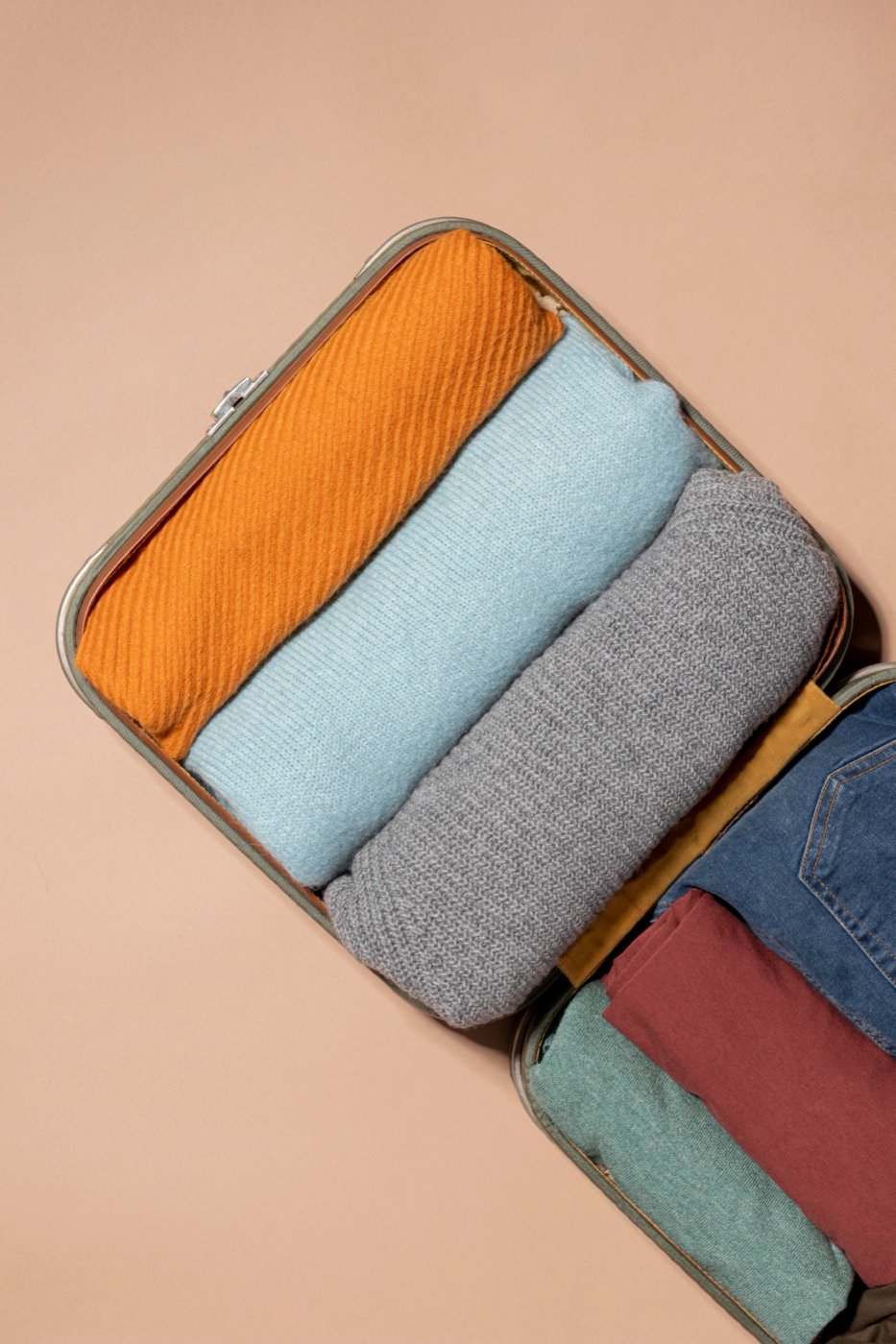 An open suitcase with clothes folded and ready to pack