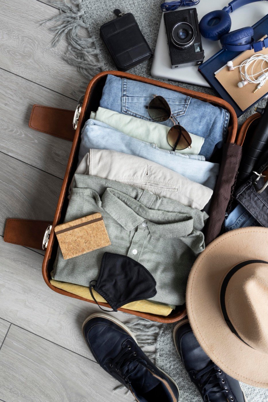 Clothes and accessories laid out in a suitcase
