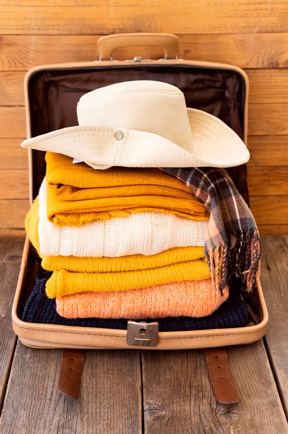 Travel essentials arranged on a piece of luggage