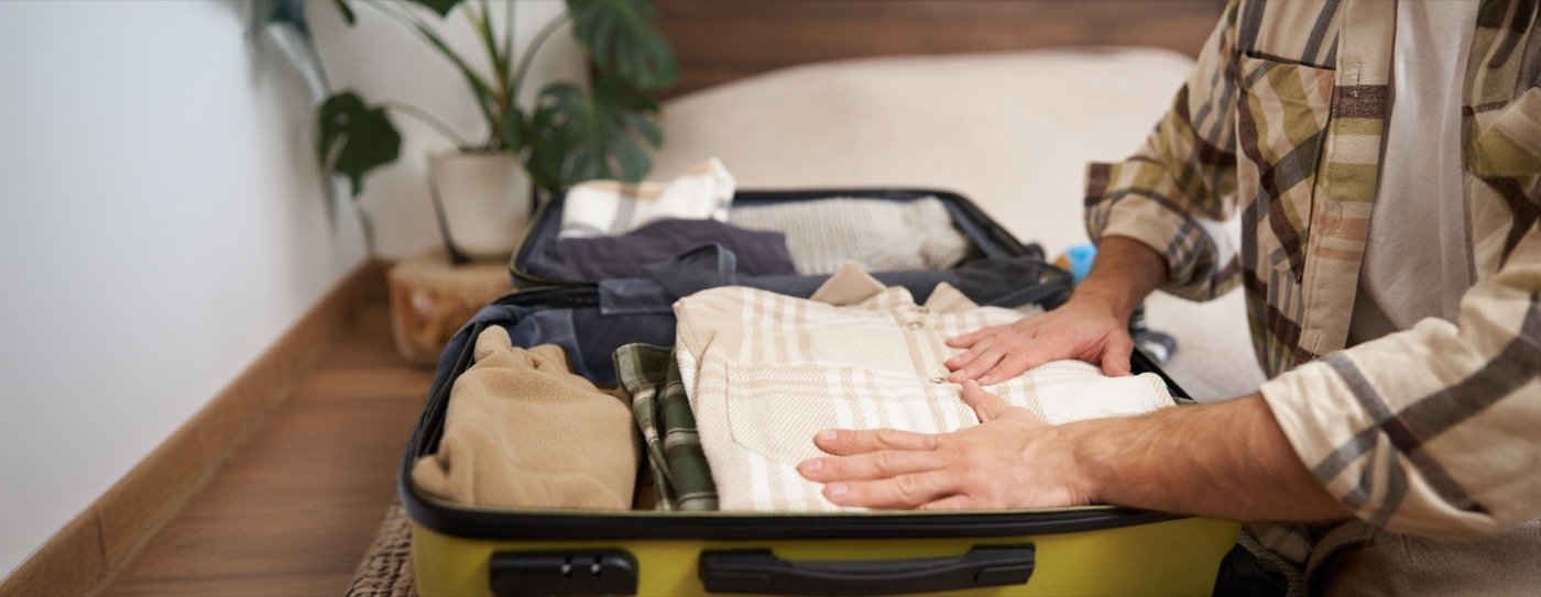 Packing clothes into a suitcase for a short trip