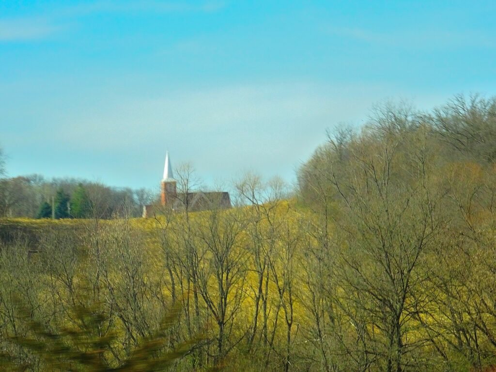 Fall foliage around a white church in a Vermont village