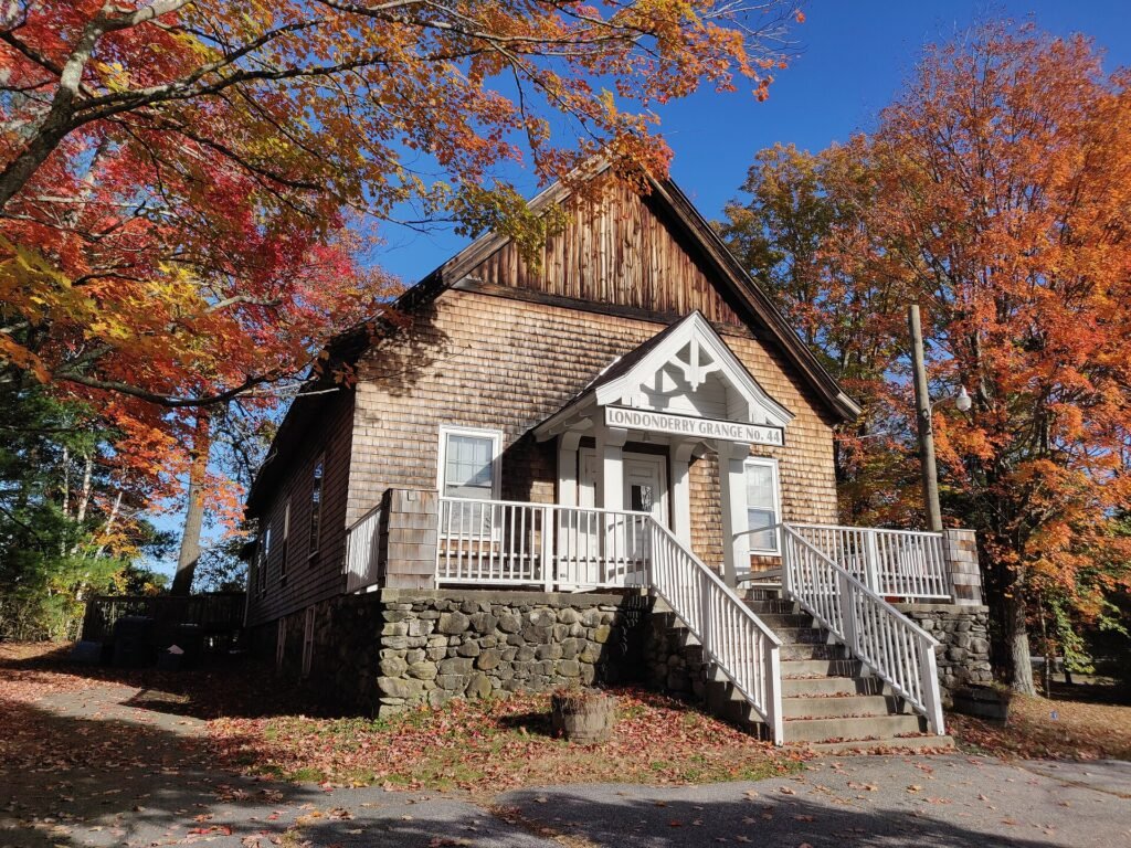 Rolling hills covered in red and orange fall foliage in New England