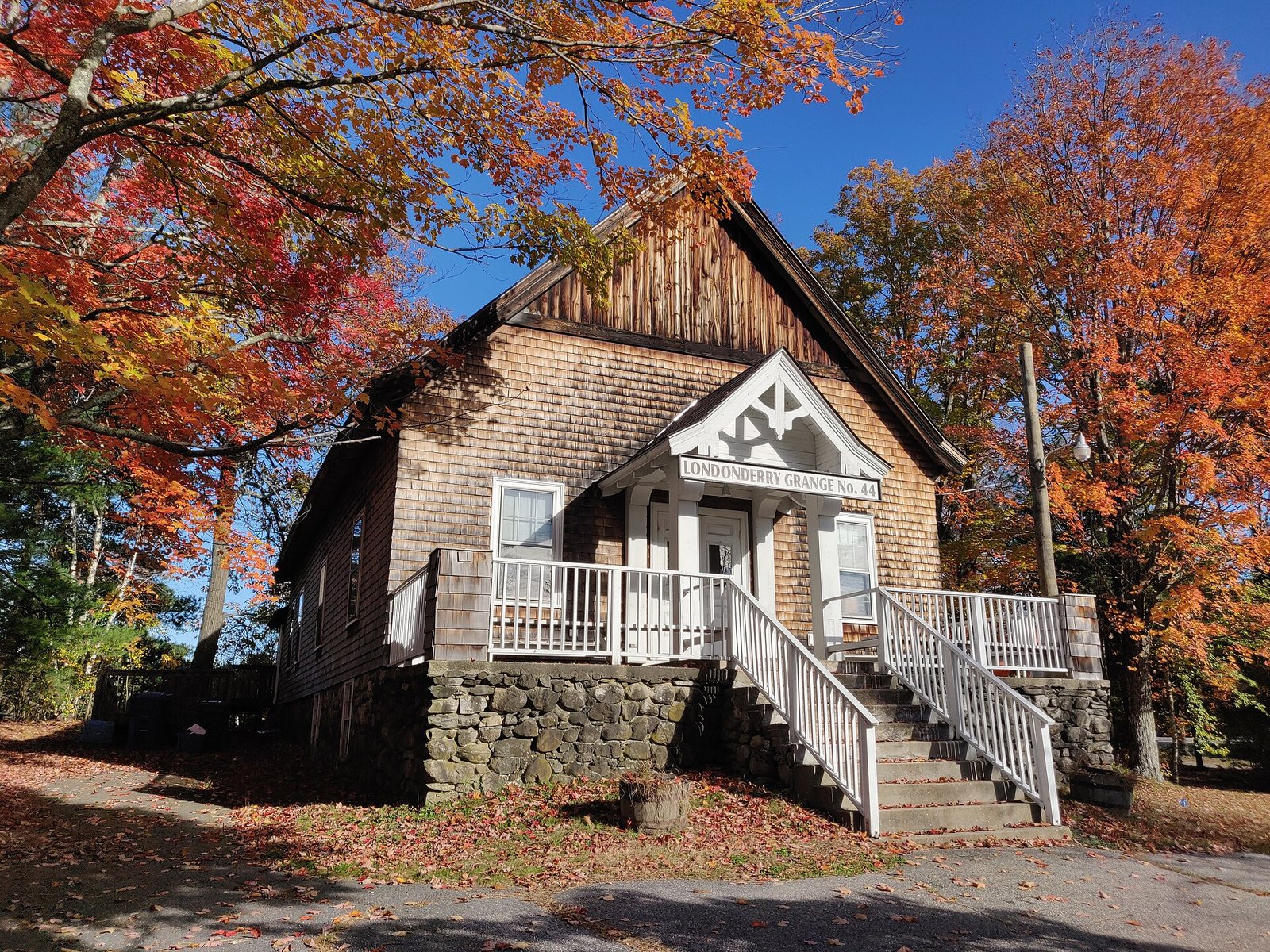 Rolling hills covered in red and orange fall foliage in New England