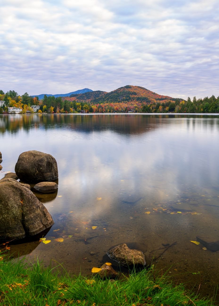 A lake reflecting autumn colour in the Adirondacks
