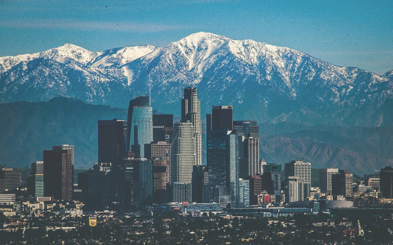 The downtown Los Angeles skyline with mountains behind it