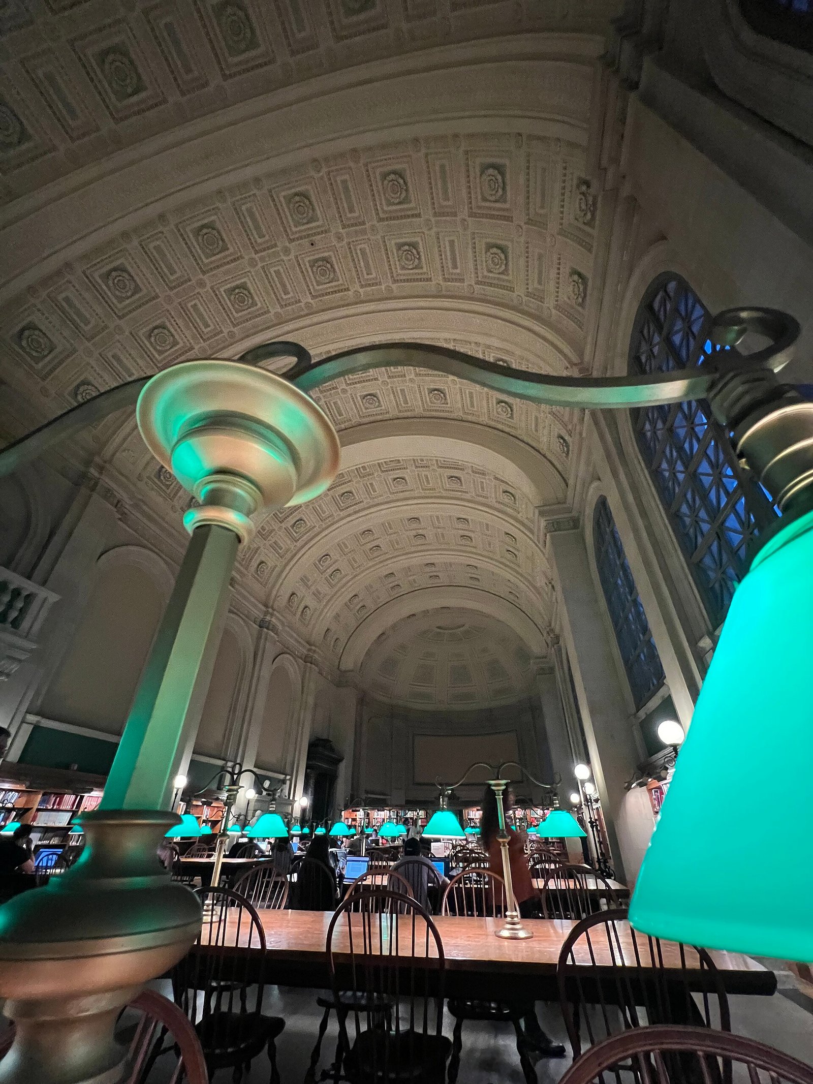 Green lamps and the arched ceiling of Bates Hall in the Boston Public Library