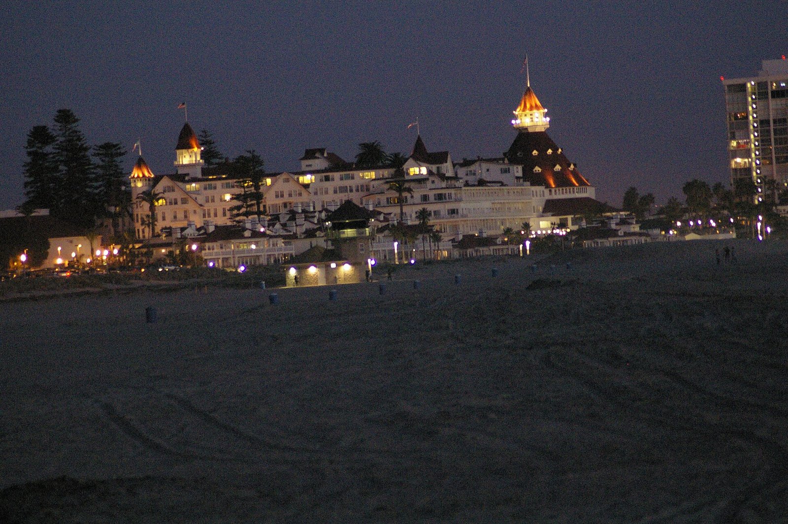 The Hotel del Coronado lit up at dusk on Coronado Beach
