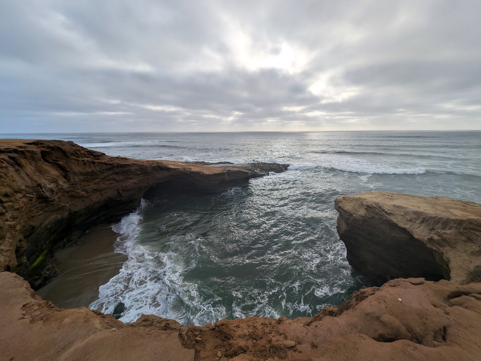 Waves washing into the sandstone at Sunset Cliffs Natural Park in Point Loma