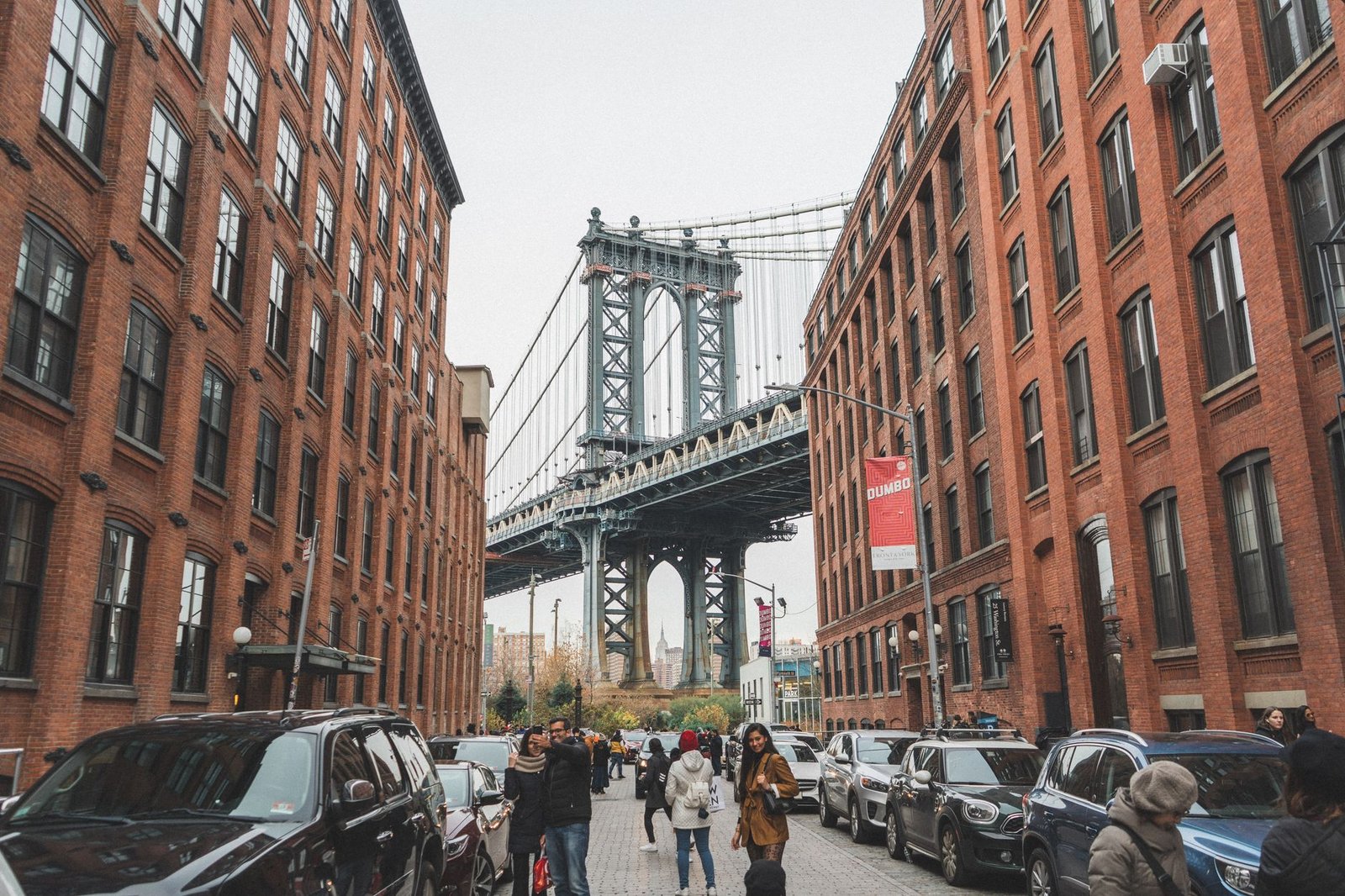 The Manhattan Bridge framed by brick warehouses on Washington Street in DUMBO, Brooklyn