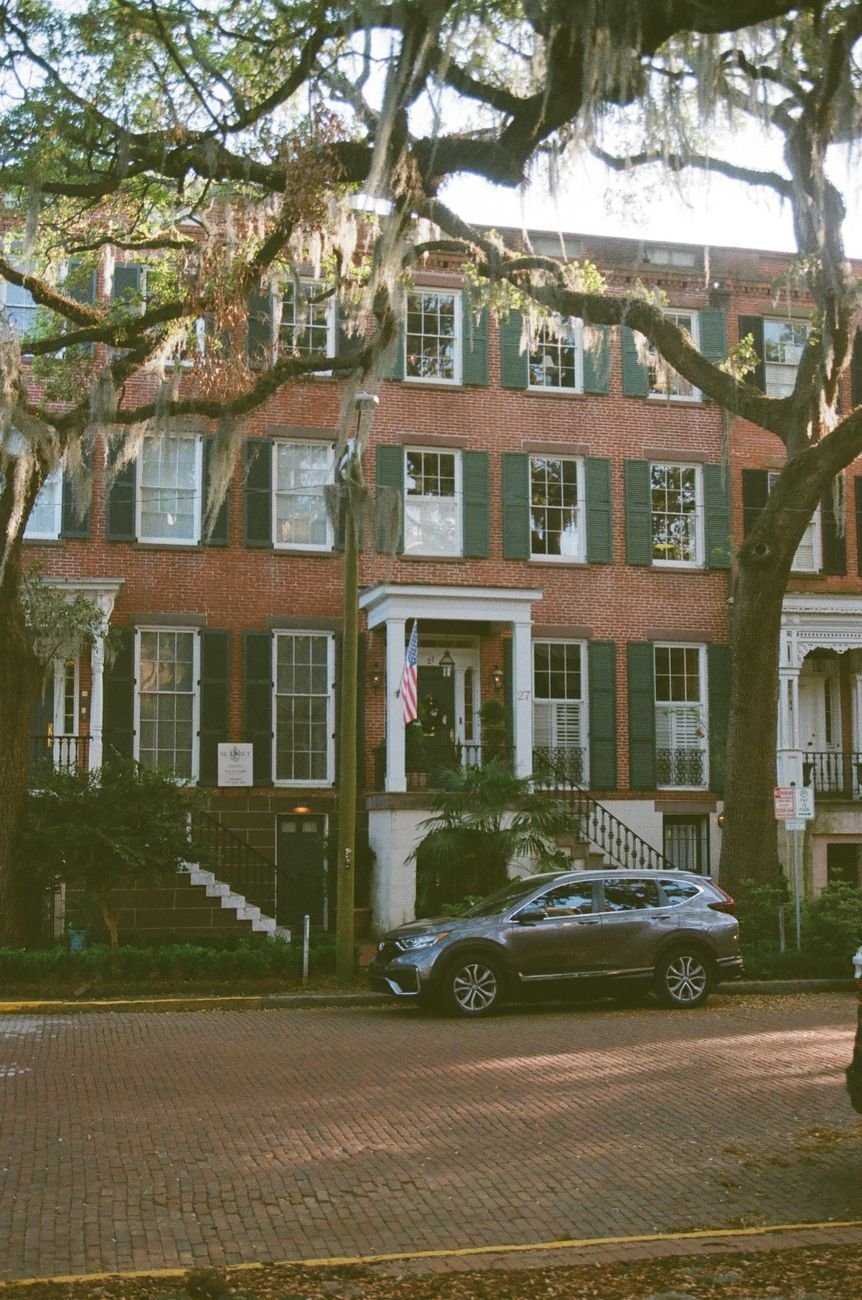 Brick townhouses and oaks along Jones Street in Savannah