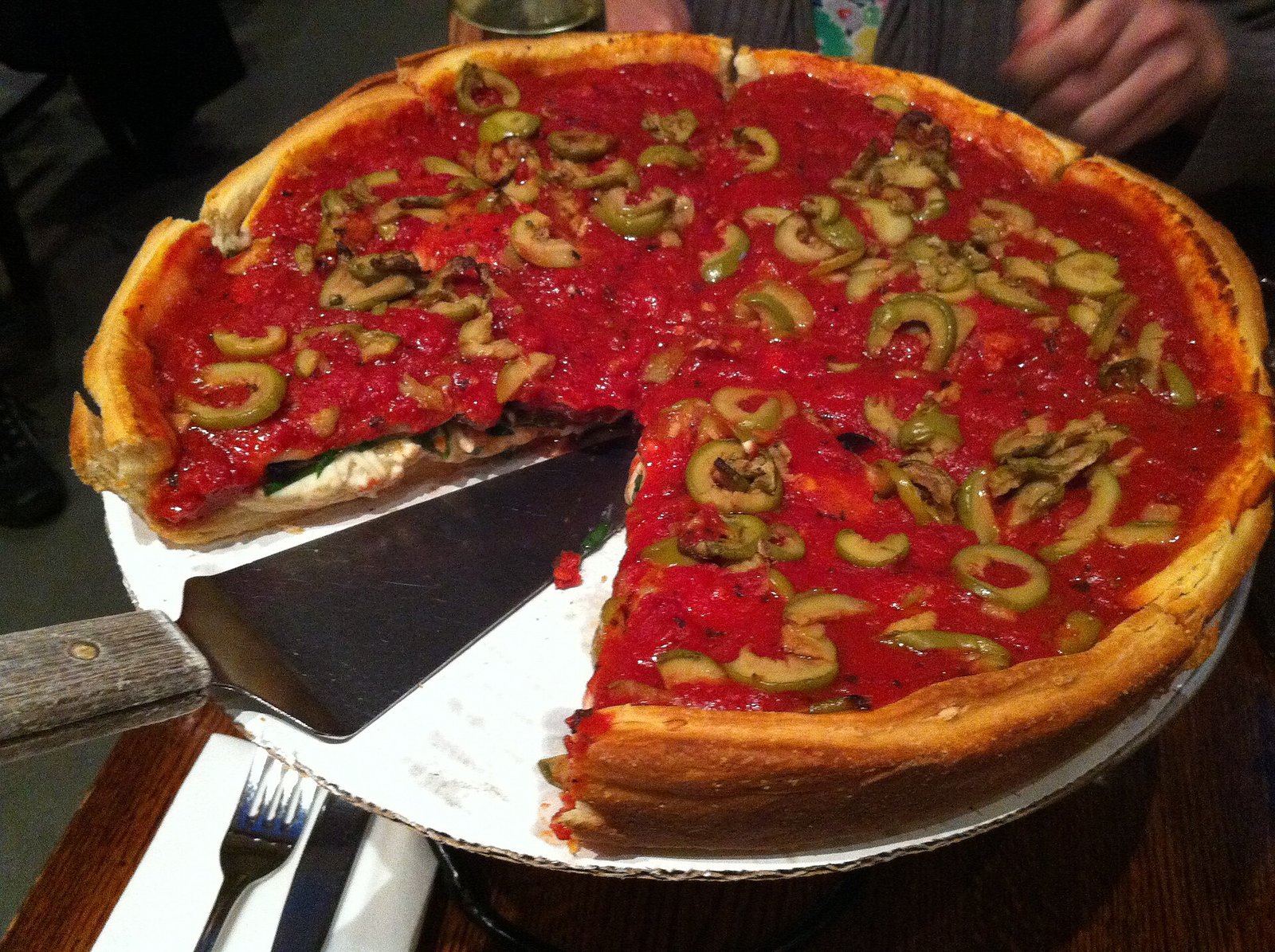 A Chicago deep-dish pizza with one slice cut out
