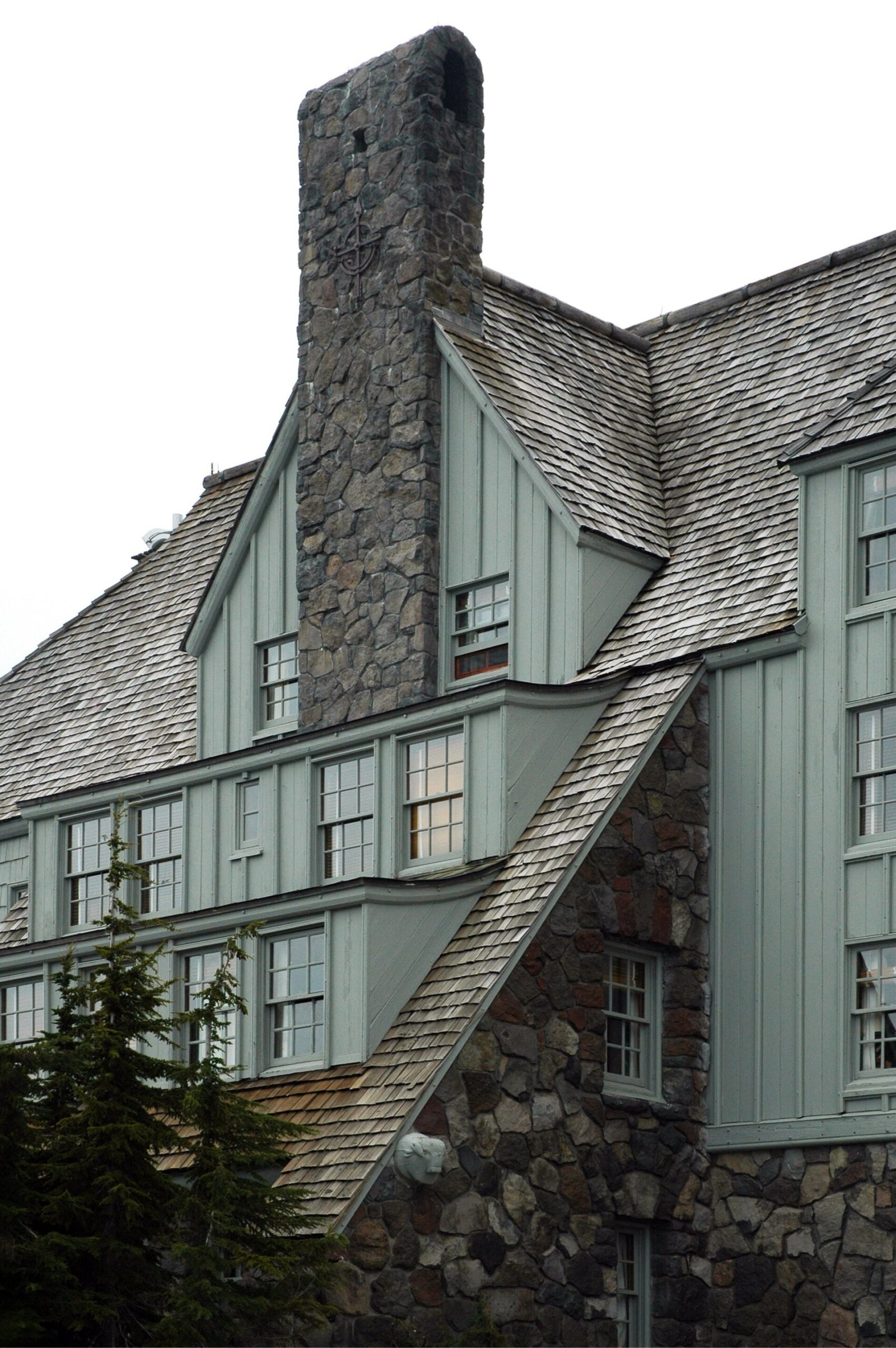 The steep roofs and stone chimney of Timberline Lodge on Mount Hood