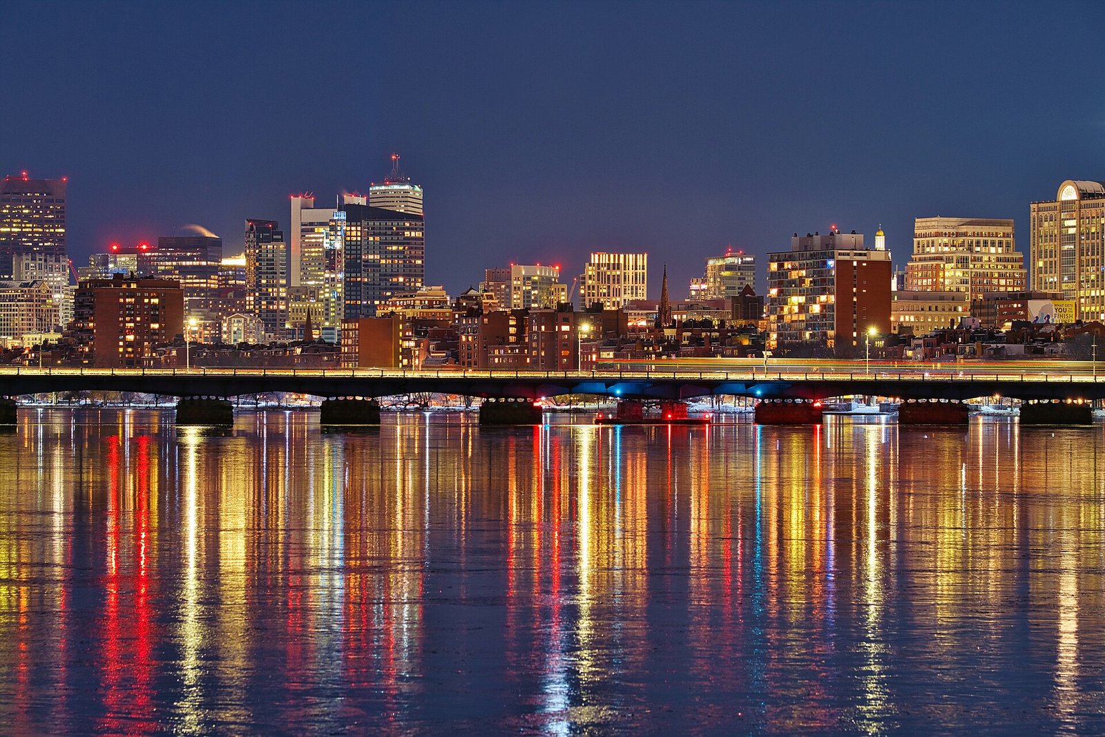 The Boston skyline reflected in the Charles River at night