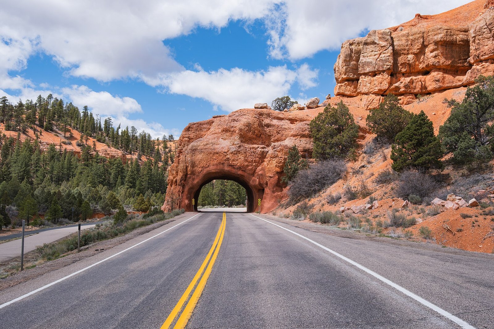A highway winding through the red rock landscape of southern Utah