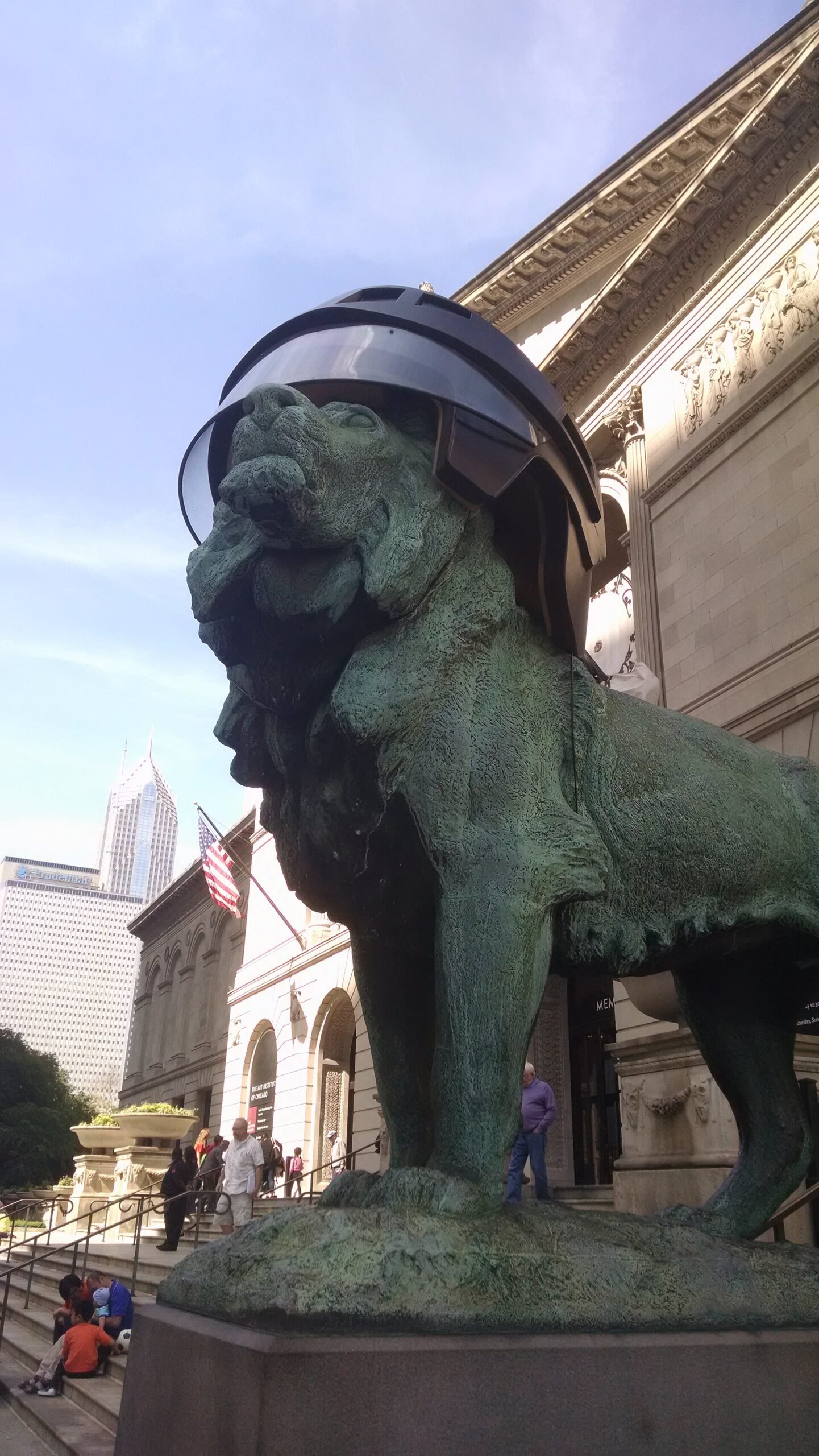 One of the Art Institute of Chicago's bronze lions, wearing a hockey helmet