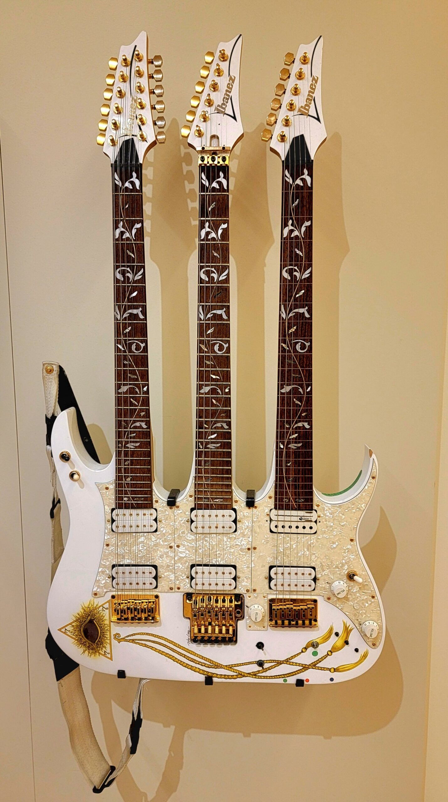 A triple-neck guitar on display at the Musical Instrument Museum