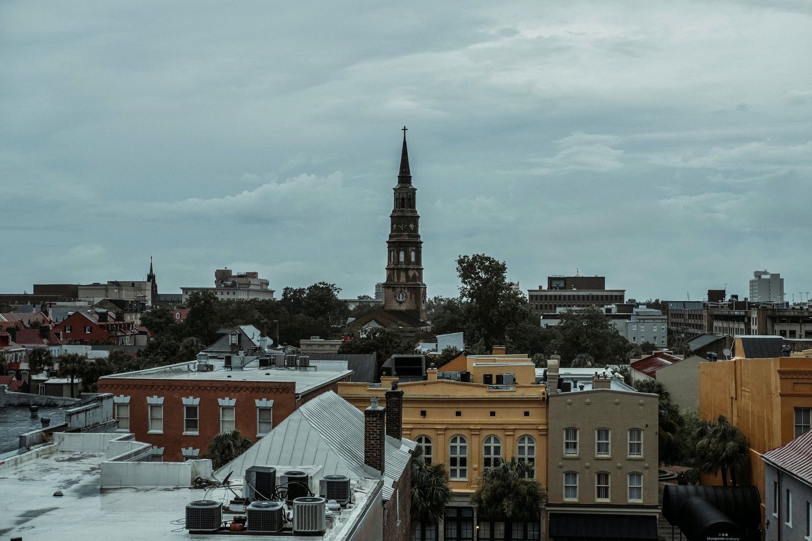 A church steeple rising over the rooftops of downtown Charleston