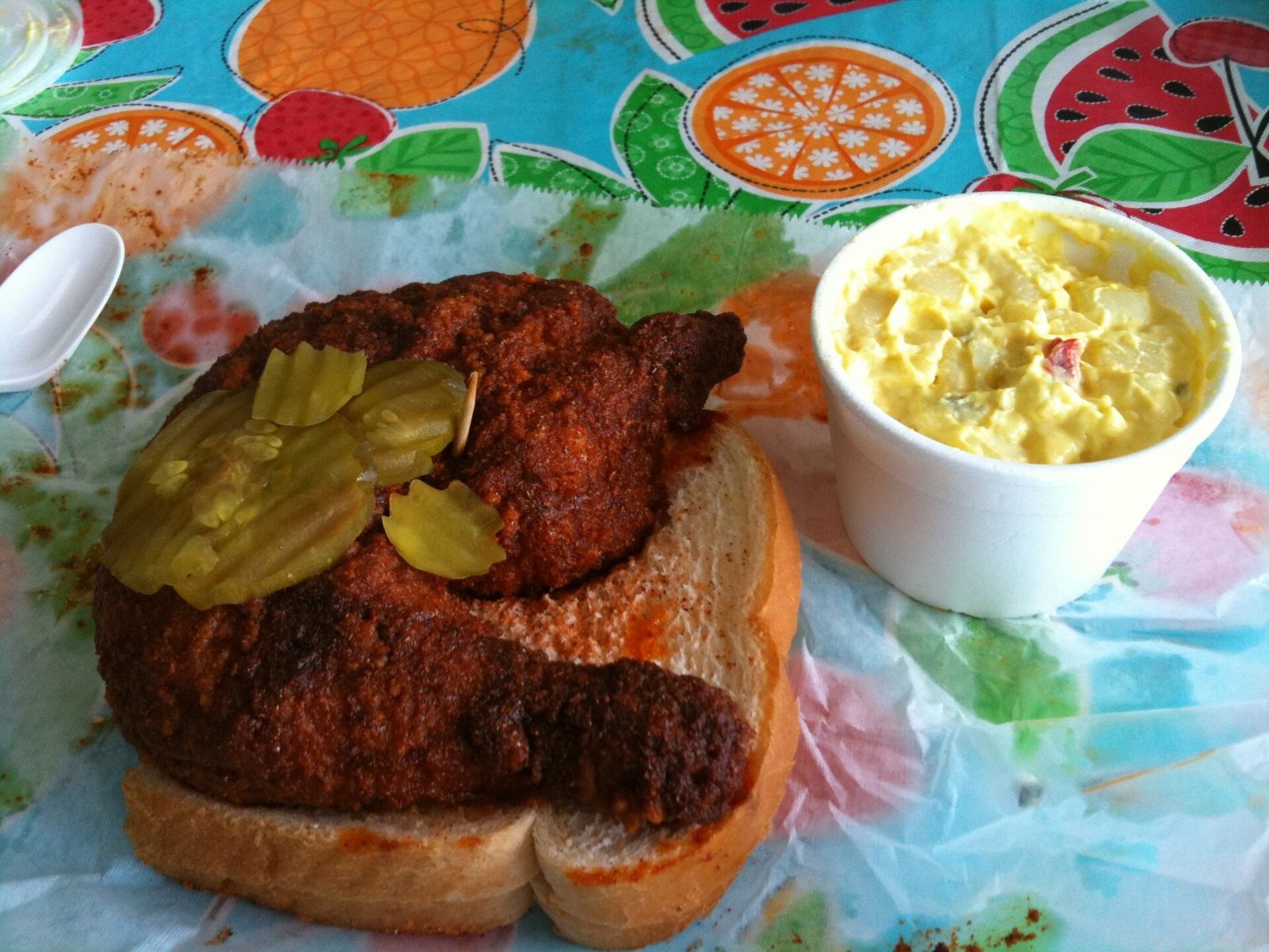 Nashville hot chicken on white bread with pickles